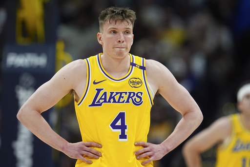 Los Angeles Lakers guard Dalton Knecht waits for play to resume in the first half of an NBA basketball game against the Denver Nuggets, Friday, March 14, 2025, in Denver. (AP Photo/David Zalubowski)
