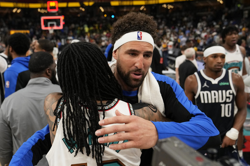 Dallas Mavericks guard Klay Thompson, right, hugs Memphis Grizzlies guard Ja Morant after an NBA play-in tournament basketball game Friday, April 18, 2025, in Memphis, Tenn. (AP Photo/George Walker IV)