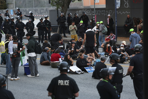 Los Angeles police officers surround protesters under arrest on Wednesday, June 11, 2025, in Los Angeles. (AP Photo/Ethan Swope)