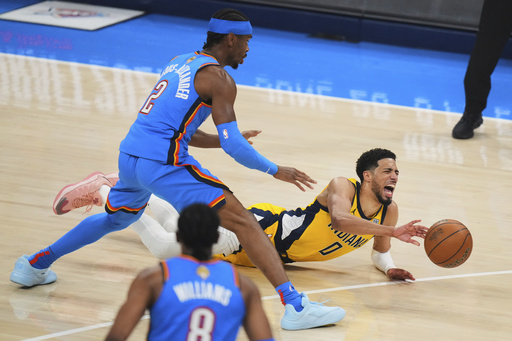Indiana Pacers guard Tyrese Haliburton (0) falls to the court