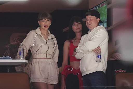 Singer Taylor Swift, left, takes in the third period in Game 4