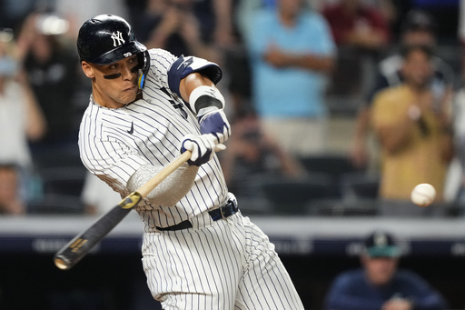 New York Yankees designated hitter Aaron Judge hits a sacrifice fly during the 10th inning of a baseball game against the Seattle Mariners, Thursday, July 10, 2025, in New York. (AP Photo/Yuki Iwamura)